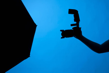 Photographer holding a dsrl camera with a flashの写真素材