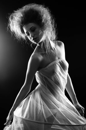 Young woman wearing a crinoline shooted over a black backgroundの写真素材