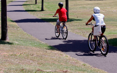 Two bicycle riders on a pathwayの写真素材