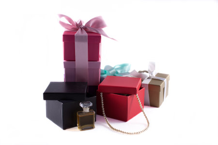 Gift boxes with pearls and perfume isolated on white