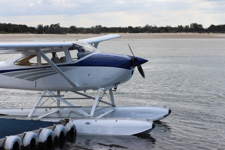Tourist seaplane docked at beach jetty