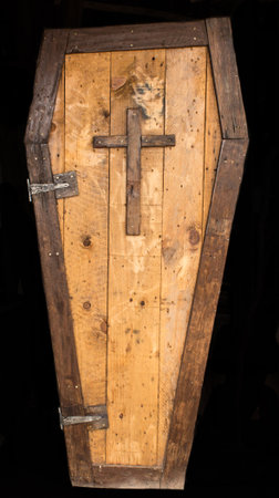 Historic convict made wooden coffin with cross isolated on black backgroundの写真素材