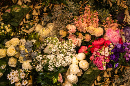 Floral display of white pink roses, daisies, flowers and green foliage ideal as background wallpaper