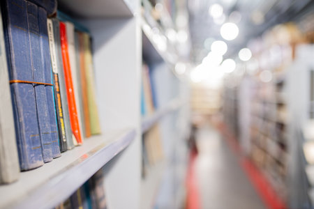 Blurred image of old books on wooden shelf. Blurred background.の写真素材