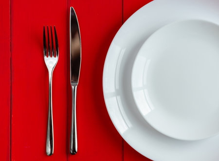 Plate and cutlery on the table. Fork and knife on an empty plate. close-up image.の写真素材