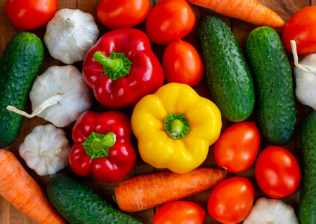 Lots of vegetables on the table. harvesting. Several tomatoes, cucumber, carrots, peppers and garlic. Suitable for vegetarians.の写真素材