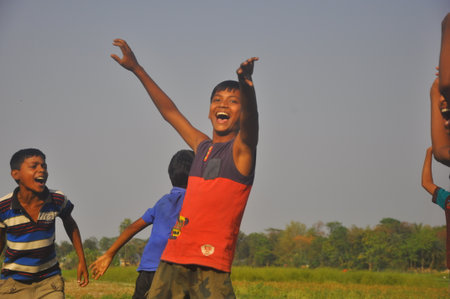 Dhaka, Bangladesh, 17 February 2018: An image of unidentified boys playing in the open field of a rural area near Dhaka, Bangladesh.のeditorial素材