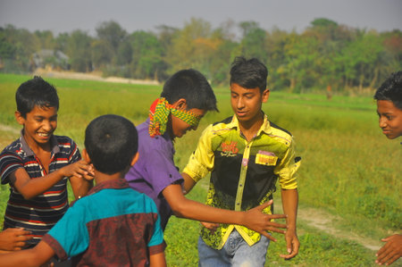 Dhaka, Bangladesh, 17 February 2018: An image of unidentified boys playing in the open field of a rural area near Dhaka, Bangladesh.のeditorial素材