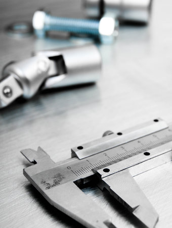 Metal style. Ð¡alliper and other metal tools on the scratched metal background.