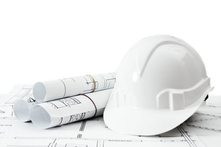 Construction house. Repair work. Drawings for building and helmet on white a background.の写真素材