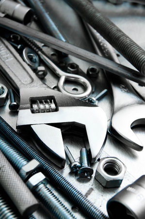 Metal tools. Metal style. Wrench and metal tools on the scratched metal background.