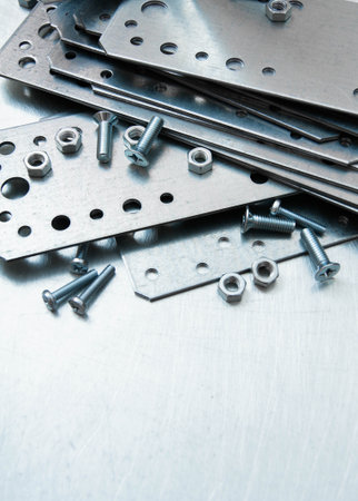 Metal working tools. Metal style. Metal preparations and fixing elements on the scratched metal background.の写真素材