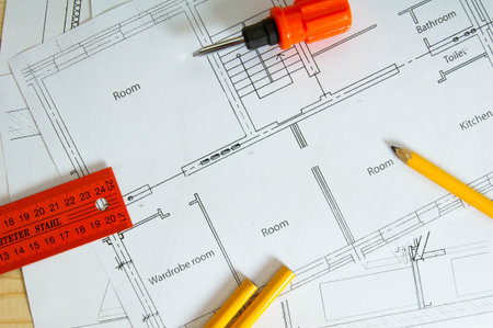 Planning of construction of the house. Repair work. Drawings for building and screwdriver on wooden...