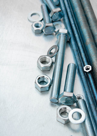 Metal tools. Metal style. Metal hairpins and bolts on the scratched metal background.