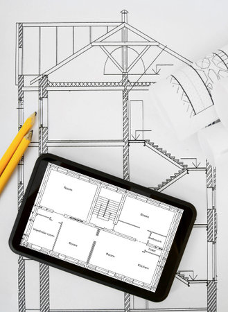 Planning of construction of the house. Tablet, drawings and working tools.