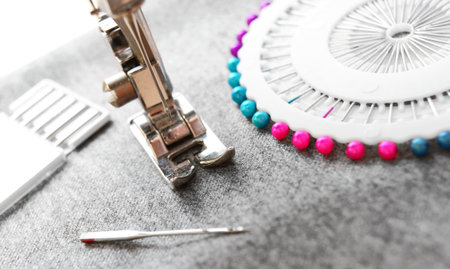 The sewing machine and needles on a fabric.の写真素材