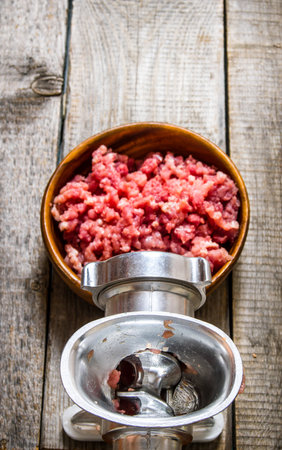 Preparated of meat. Cooking minced meat grinder. On a wooden table. Top viewの写真素材