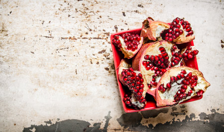 Fresh pomegranate in a cup. On the rustic background. Free space for text . Top viewの写真素材