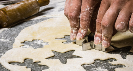Preparation of the dough . Making cookies from fresh dough . On the stone table with flour.