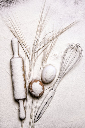 Preparation of the dough. With the rolling pin whisk and ears of wheat in flour. Top viewの写真素材