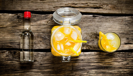 Fresh orange cocktail . Orange cocktail with vodka and ice on a wooden table. Top view