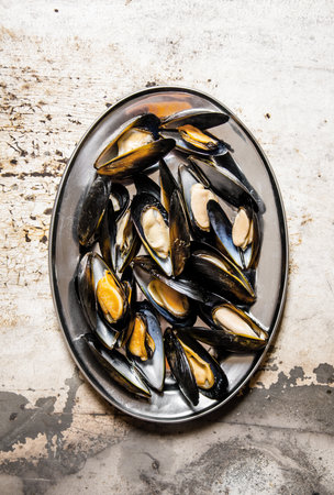 Clams on a tray. On rustic background. Top viewの写真素材