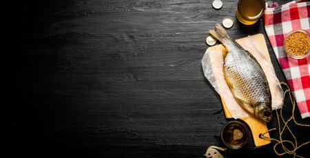 Beer background. Dried fish and fresh beer on a chalkboard. Free space for text. Top view