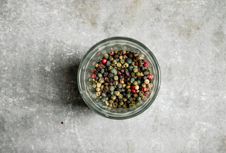 Peppercorn in a glass saucer. On a stone background.の写真素材