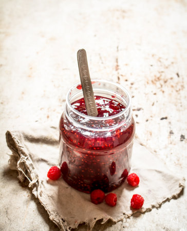 Jam from wild raspberries in the jar. On rustic background .の写真素材