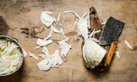chopped cabbage in a pot and an old hatchet. On wooden background.の写真素材