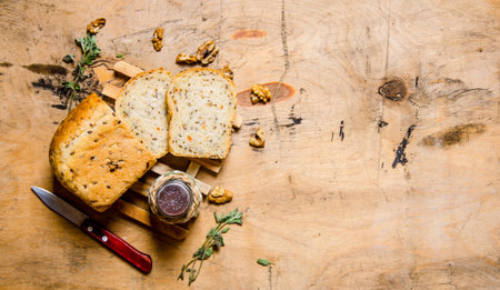 Sliced bread with salt and a knife . On a wooden table. Free space for text . Top viewの写真素材