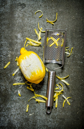 Clean the lemon with a cheese grater. Lemon zest. On the stone table. Top viewの写真素材