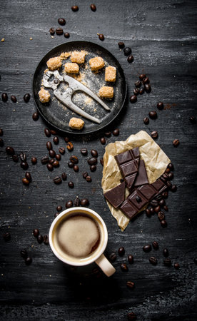 A Cup of coffee with bitter chocolate and dark brown sugar. On black rustic background.の写真素材