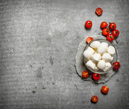 Fresh mozzarella with tomatoes. On the stone table.の写真素材