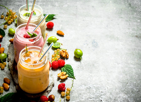 Berry smoothies with nuts. On a stone background.の写真素材