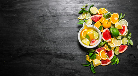 The citrus juice from citrus fruit - grapefruit, orange, tangerine, lemon, lime . On a black wooden background. Free space for text . Top viewの写真素材