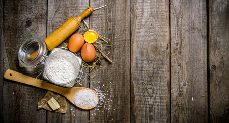 Preparation of the dough. Ingredients for the dough - flour, eggs, salt and butter. On a wooden...