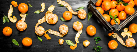Fresh tangerines in a box. On the black chalkboard.の写真素材
