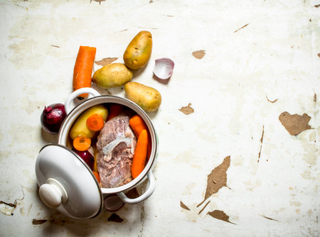 The pot of soup from meat and vegetables. On rustic background.の写真素材