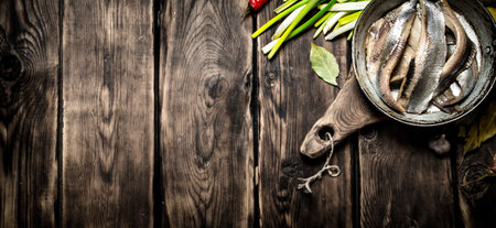 Fillet of salted herring with fresh onions. On a wooden table.の写真素材
