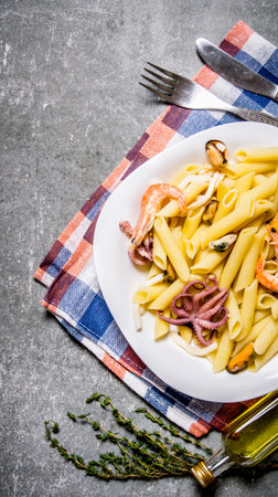 Pasta with seafood on a plate on the fabric. On the stone table. Top viewの写真素材