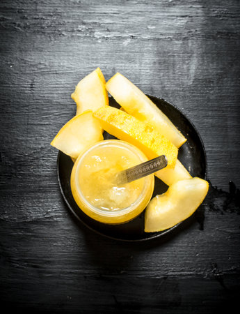 The juice from the melon . On the black wooden table.の写真素材