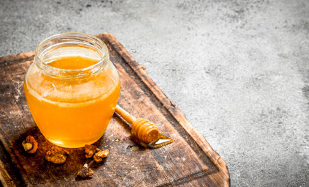 Fresh honey with nuts. On rustic background.の写真素材