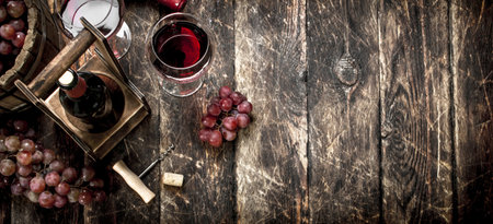 Wine background. Red wine with glasses with grapes. On a wooden background.の写真素材