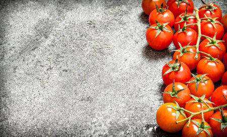 Fresh ripe tomatoes. On the rustic background.の写真素材