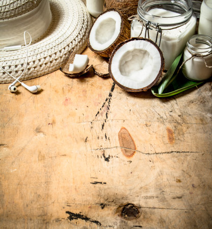 Summer cocktail. Coconut milk with a summer Panama hat.On wooden background.の写真素材
