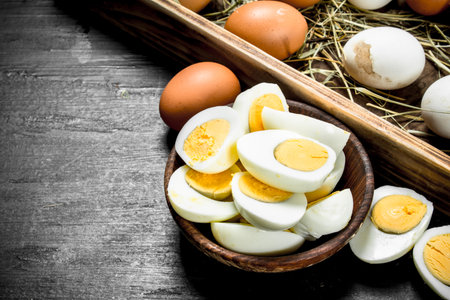 Boiled eggs in a bowl. On the black chalkboard.の写真素材