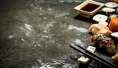 Sushi rolls with seafood and soy sauce. On the stone table.の写真素材