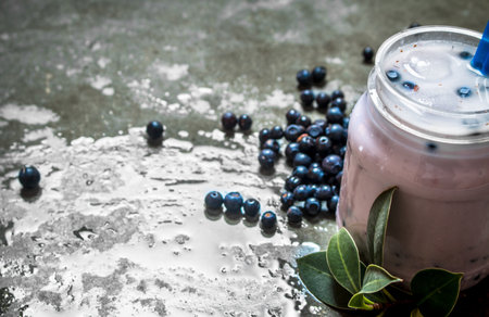 Blueberry smoothie with ice. On a stone background.の写真素材