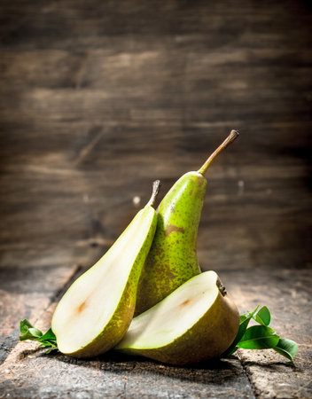 Fresh pears with leaves. On a wooden background.の写真素材